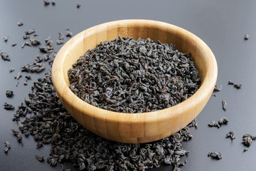 black tea leaves in a wooden bowl