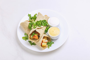 Vegetarian masala dosa with potato, chutney and sambar sauces.