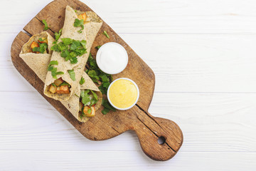Vegetarian masala dosa with potato, chutney and sambar sauces.