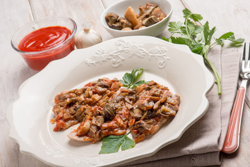 veal escalope with boletus and tomatoes sauce