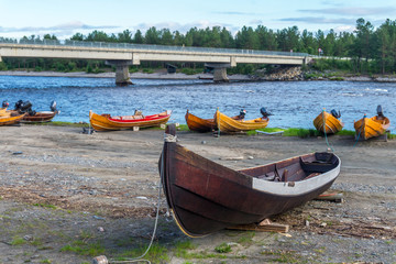 Fototapeta na wymiar Wooden boats on the bank of river, Finnmark, Norway