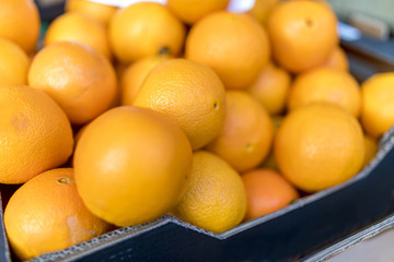 Close up of fresh juicy large Spanish Naval oranges on a traditional market stall in England, UK
