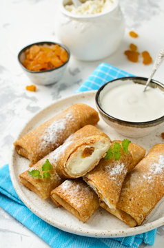 Pancakes stuffed with cottage cheese and raisins