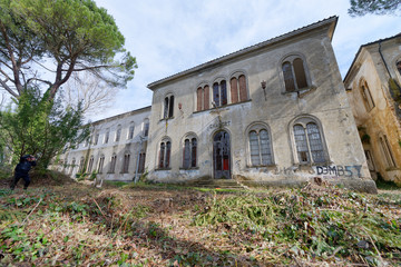 VOLTERRA, ITALY - FEBRUARY 24, 2018: Exterior view of Charcot building. It is part of the of abandoned asylum, closed in 1984