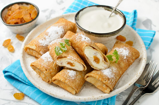 Pancakes stuffed with cottage cheese and raisins
