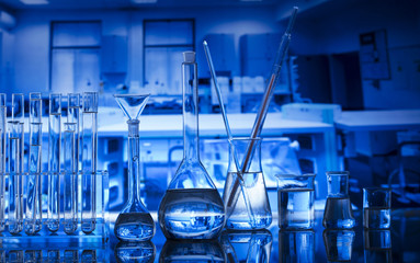 Science Concept. Laboratory Research and Development. Scientific glassware for chemical experiment. Microscope, laboratory beakers, test tubes, pipettes. Lab interior background.