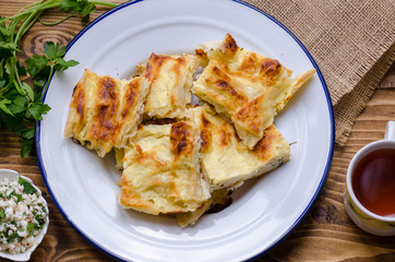 traditional turk börek, crumb börek, yufka, oil, yoghurt, parsley and cheese.