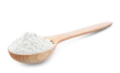 Wheat flour in wooden spoon on white background