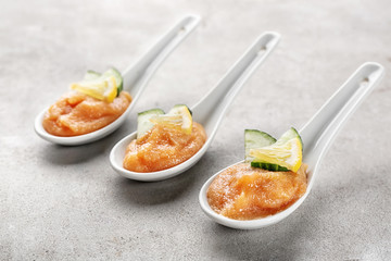 Spoons with codfish caviar on table