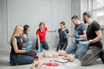 Stay away moment during the defibrillation process on a first aid group training indoors - obrazy, fototapety, plakaty