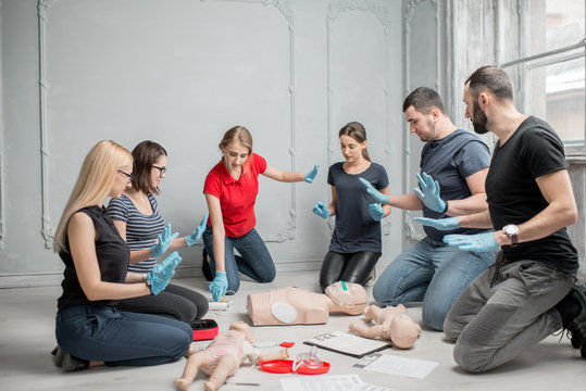 Stay away moment during the defibrillation process on a first aid group training indoors