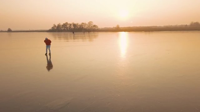A man is skates on a natural frozen lake in the Netherlands.