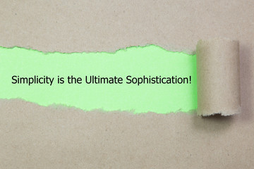 Motivational quote Simplicity is the Ultimate Sophistication, appearing behind torn paper.