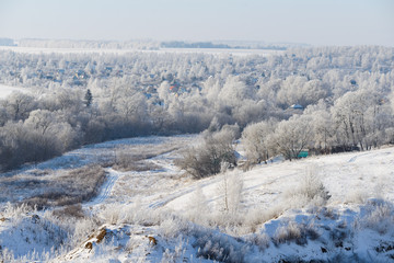Fototapeta na wymiar Rural winter landscape with white frost in the ravine