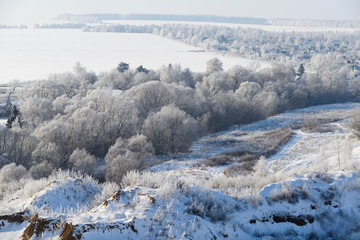 Rural winter landscape with white frost in the ravine