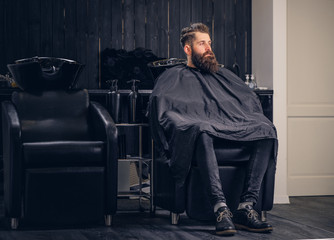 Handsome bearded man in the barbershop.