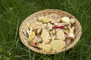 Czech easter gingerbread in wicker basket in the garden, comical bunnies