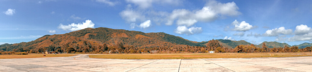Fototapeta na wymiar Tropical airport runway, panoramic view