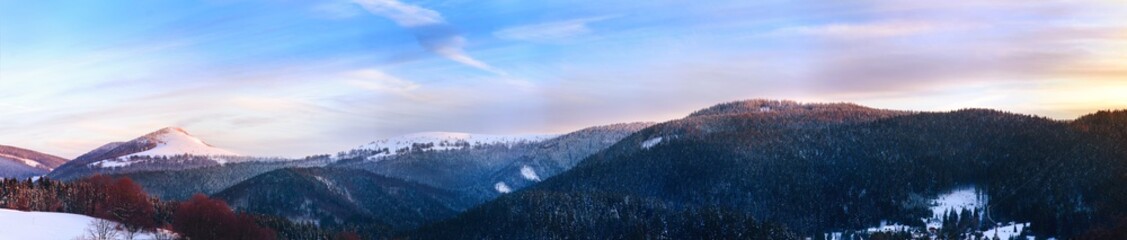 Fototapeta na wymiar Panorama of the snow-capped mountains. Ski resort