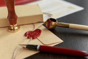 Fountain pen and old notarial wax seal on document, closeup