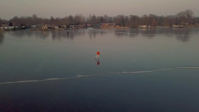 A man is skates on a natural frozen lake in the Netherlands.