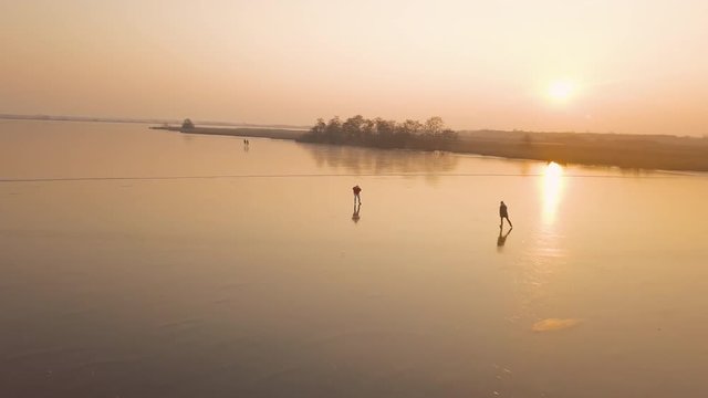 A man is skates on a natural frozen lake in the Netherlands.