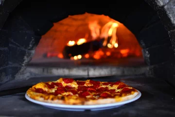 Foto op Plexiglas Pizza in a stone fire stove of an italian restaurant. © Dmytro