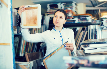 Adult woman is standing with modern pictures