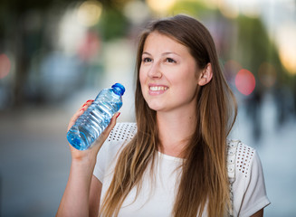 Woman quenching thirst with water