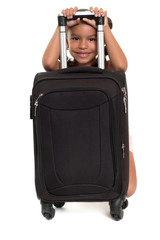 Cute african american girl hiding behind a travel suitcase