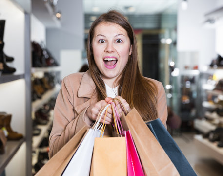 Portrait of woman customer which is showing purchases