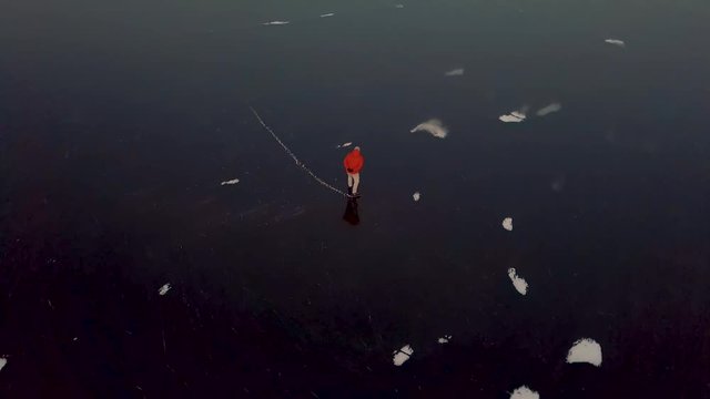 A man is skates on a natural frozen lake in the Netherlands.