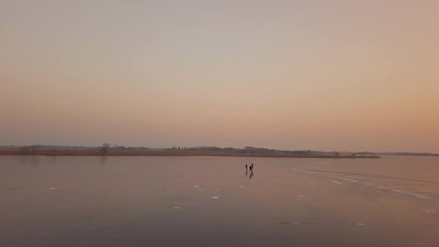 A man is skates on a natural frozen lake in the Netherlands.