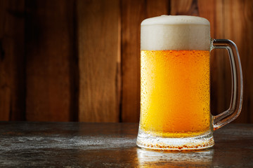 mug with beer on a wooden background