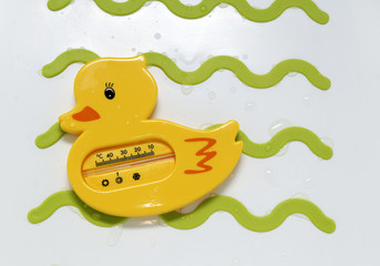 Funny yellow duck thermometer for meashurement of water temperature during newborn baby bath in a...