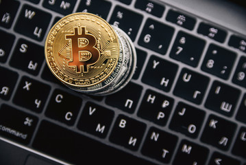 Gold bitcoin on the coins stack, digital money on computer keyboard. Cryptocurrency business concept. Virtual money investment. Cryptocurrency maining.