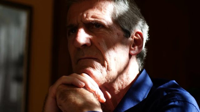 Pensive mature man reflecting on the future- close up portrait