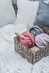 Balls of  super chunky merino woolen yarn with needles