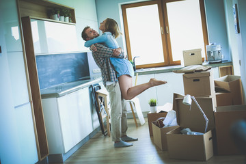 Fototapeta premium Portrait of young couple moving in new home. Young couple