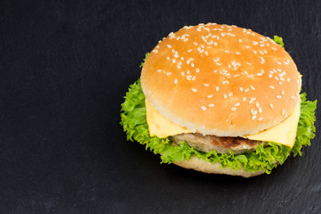  fresh tasty burger on black textured background