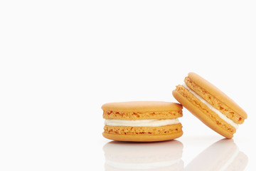 Assorted macaroons over white background with reflection.