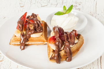 dessert waffles with banana, strawberry, chocolate and ice cream