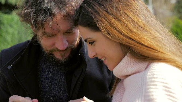 Man taking ring from box to put on finger of girlfriend slow motion