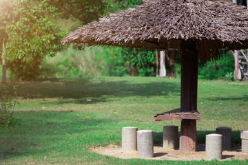 Fototapeta na wymiar Furniture covered by umbrella in garden for relaxing.