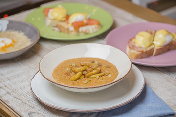 porridge with slices of baked apple and raisins, restaurant dish