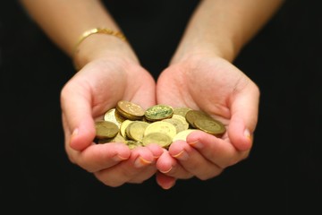 women hand with handful of coins