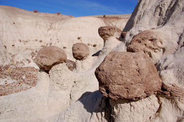 Round, pitted, natural sandstone rocks in the desert badlands of Bisti/De Na Zin in Northern New Mexico