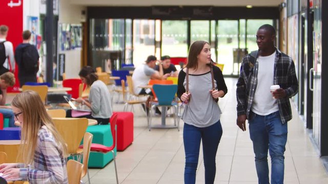 Communal Area Of Busy College Campus With Students