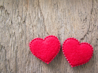 Naklejka na ściany i meble Two red heart on wood background