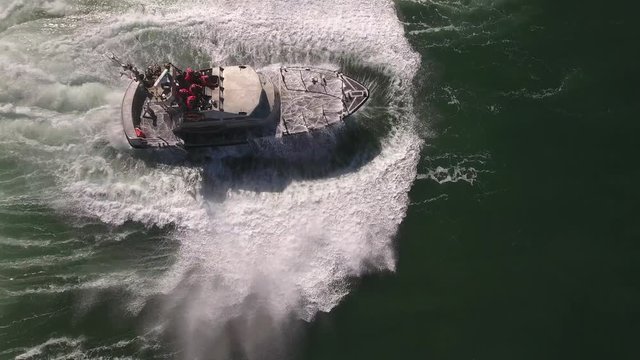 looking down epic wave over coast guard, rough seas, rouge wave crashing over boat water, Drone aerial video, 4k, rescue, marine, pacific, tide, surge, danger, dangerous waves raw